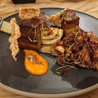 Porq Belly: Juniper and bay braised porq seitan, carrot and star anise puree, umami glaze, sous vide charred fennel, spiced apple and cabbage bhaji, five spice crackling. at Offbeet - New Forest in Southampton