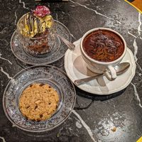 Traditional hot chocolate and coconut milk, chocolate macadamia nut cookie, 2 pequeño  scoops of chocolate and passion fruit ice cream. at Bombon in Madrid