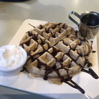 Waffle with coconut cream, chocolate sauce and syrup at Cafe Con Todo in Seattle