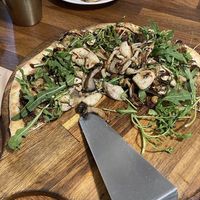 Incredible mushroom pizza - includes vegan pesto and ricotta, variety of cooked mushrooms, and topped with fresh arugula  at Nammi Plant Lab in Seoul