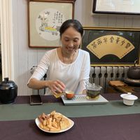 Yuan Jie, the owner, giving me free tea and accompanied sweets at Taiping Old Farm  in Beijing