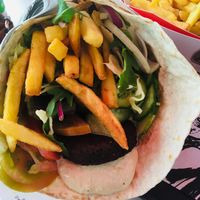 Vegan falafel wrap with homous, mixed salad and chips. Very hefty, €9 but very substantial and didn’t need any dinner after this for lunch! at Georgie's Handy Food in Ayia Napa