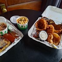 Collard greens, cole slaw, mac, corn bread, jackfruit ribs, onion rings. at Trio Plant-Based in Minneapolis