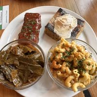Soul food platter with ribs, corn bread, Mac and cheese, and collard greens   at Trio Plant-Based in Minneapolis
