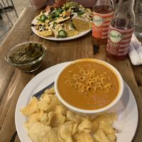 Spaghet-Trios, side of collards, and nachos. Wisco-pop is tasty + full of sugar. at Trio Plant-Based in Minneapolis