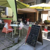 Outdoor dining and veggie carts   at Bilobi Laden & Cafe in Strobl