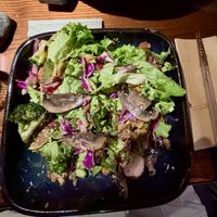 Grilled sweet potato, avocado, cauliflower and portobello mushroom on a salad of green leaves, red cabbage, quinoa, tomatoes, edamame, radish, broccoli and sesame topped with goma  at Sticks N Sushi in Copenhagen