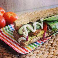 Sandwich with tofu burgers, vegan cheese, garlic and nettle sauce, pickles and red onion at Długa Buła in Torun