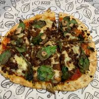 Pizza with the zero sausage, vegan cheese, spinach and mushrooms at Azzip Pizza in Bloomington