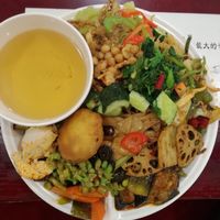 Plate piled hiiiigh, hot mess is this at Qiānhé Qīngxīn 谦和清心素食 - 星辰路 in Chengdu