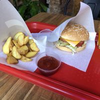 Happy pig burger with potato wedges and ketchup at Complex Burger in Moscow