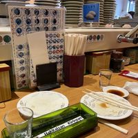 The Counter with the hot water taps and the free matcha tea powderr  at Himawari Zushi Shintoshin in Tokyo