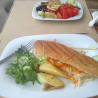 Gorgeous hot dog and small meze. at Aubergine Cafe in Corfu