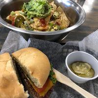Classic Meta Burger (pickles in the side) and Nachos (added guacamole).  at Meta Burger in Denver