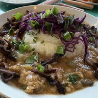 GRITS AND GRILLADES
creole Gravy + oyster mushroom bacon + blackeyed pea sausage  at Fog Eater Cafe in Mendocino