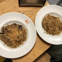 On the left wholegrain noodles with shitake, Teriyaki sauce and fried garlic, on the right udon noodles with mushrooms and garlic-black pepper sauce at Wok to Walk in Riga