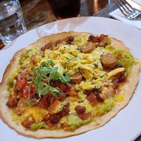Vegan huevos rancheros (gluten-free tortilla, beans, avocado, salsa, vegan
sausage, vegan grated cheddar with vegan scrambled eggs with chives) at The Bike Shed Motorcycle Club in London