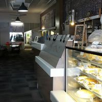 Indoors are century-old pressed metal ceiling, 1950s tables and chairs and kitsch wall-panel pictures at Belle Vue Cafe in Warwick