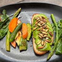 Avocado toast ordered vegan (with extra veggies instead of egg)  at Papaya Playa Project in Playa Del Carmen