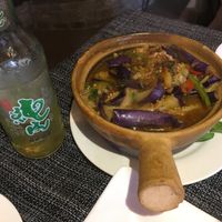 Eggplant in clay pot and local beer at Pure Lotus in Yangshuo