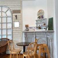 Indoor seating area with a high chair and tchotchkes at Juicygreens in Jamaica Plain