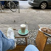 Coffee, vegan croissant and cute little sparrows  at Early Bird in Berlin