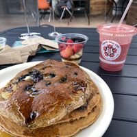 vegan multigrain blueberry banana pancakes, cup of fruit, and the vegan tropical thunder smoothie !! at Middle Way Cafe in Anchorage