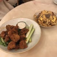 Buffalo cauliflower wings + poutine!!!  at Fresh Kitchen & Juice Bar in Toronto