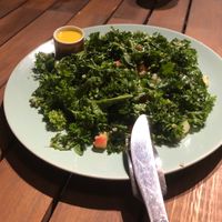 organic kale salad cho tín đồ raw at Roots Plant-Based Cafe in Da Nang