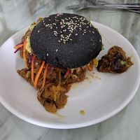 Jackfruit burger (a la pulled pork) in a spooky black (charcoal) bun  at Roots Plant-Based Cafe in Da Nang