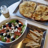 Greek salad with sliced focaccia at Vegrano in Lucca