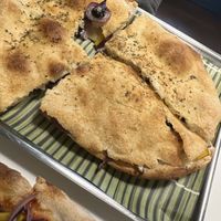 Focaccia with olives, bell pepper, cheese, olives   at Vegrano in Lucca