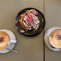 Cappuccinos and a cinnamon swirl  at Cafe Blå in Copenhagen