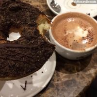 Vegan Oreo doughnut taken away to enjoy with a hot chocolate at DoughNotts in Derby