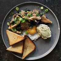 Fried egg with smoked mushrooms, roasted red cabbage and scorched spring onion cream, served with toast at Rabarber in Utrecht