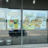 Store Sign advertising Thursday specials and Vegan Cheeze and Burrito Sauce  at Burrito Boyz in Waterloo