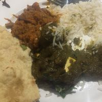 White basmati rice, An eggplant curry, vegan naan, and Saag Alu. I highly recommend the Saag Alu!!! at The Masala Twist in Oxnard