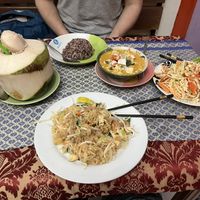 Pad thaï, red curry, papaya salad and fresh coconut   at May Kaidee in Bangkok
