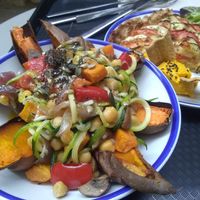 Stuffed sweet potatoes, and quiche with homemade spread on the side at Curcuma Green Food in Burgos