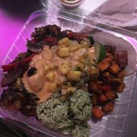 Feel real veggie bowl with sweet potatoes, black beans, guac, guac rice, brussel sprouts, peppers and onions, pineapple salsa, and vegan queso (so good) at Taco Dirty in Tampa