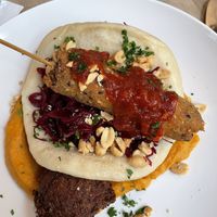 Millet satay skewer, bao bun, sweet potato peanut puree, red cabbage and more  at Du Nord in Bern