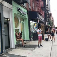 View from the street, fresh colors, bench  at Van Leeuwen Ice Cream - Upper East Side in New York City