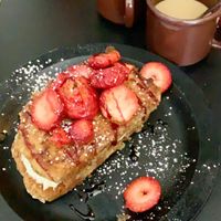 What She Said 
vanilla cookie encrusted vegan sourdough French toast stuffed with Bavarian creme - topped with fresh strawberries at The Tomcat Cafe in Sinking Spring