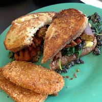 French toast bread which sandwiches JUST egg, sautéed spinach, black beans, and meatless sausage. Smothered & topped with maple syrup.  at The Tomcat Cafe in Sinking Spring