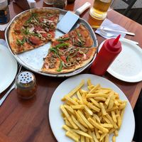 Vegetarian pizza with no cheese and French fries at Calypso in Puerto Baquerizo Moreno