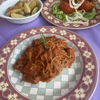 Vegan Spaghetti with Seitan Ragu, pistachio stuffed tomatoes and baked rosemary potatoess  at Ristoro Dantesca in Pisa