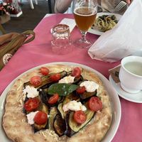 Great vegan pizza with eggplant and vegan ‘stracciatella’ which is a vegan cheese. And the non-clam spaghetti with shelled pistachios and seaweed   at Ristoro Dantesca in Pisa
