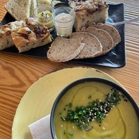 Bread basket with spreads and soup of the day  at Orteá - Vegan Collective in Lisbon