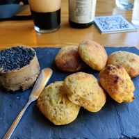 Vegan cheese covered with pepper, gluten-free breads baked at the very moment at Orteá - Vegan Collective in Lisbon
