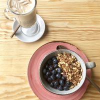 Iced caramel coffee with açaí bowl  at Orteá - Vegan Collective in Lisbon